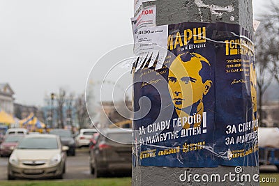 Kiev, Ukraine - December 28, 2017: Poster depicting the leader of the nationalists Stepan Bandera with an appeal to come to the ma Editorial Stock Photo