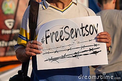 Kiev, Ukraine - July 13, 2018: Male protester stands and holds a broadsheet demanding to free Ukrainian citizen Oleg Sentsov from Editorial Stock Photo