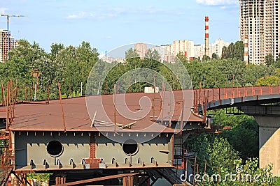 Unfinished part of the bridge over the river. Rusty metal structure of the bridge Editorial Stock Photo