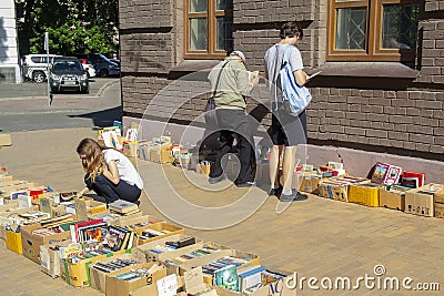 Kiev, Ukraine - May 19, 2019: Peoples buy old books at a flea market on street Editorial Stock Photo