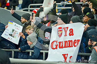 KIEV, UKRAINE - November 29, 2018: Fans and ultras of FC Arsenal with poster support the team during the UEFA Europa League match Editorial Stock Photo