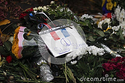 KIEV,UKRAINE - November 14, 2015: People lay flowers at the French Embassy in Kiev in memory of the victims terror attacks in Pari Editorial Stock Photo