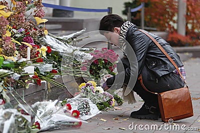 KIEV,UKRAINE - November 14, 2015: People lay flowers at the French Embassy in Kiev in memory of the victims terror attacks in Pari Editorial Stock Photo