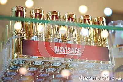 Kiev, Ukraine 19 September, 2018: Belarusian cosmetics Luxvisage lipstick in gold cases. A lot of lipstick on a glass shelf in Editorial Stock Photo