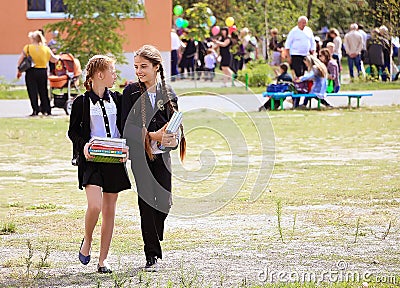 Kiev Ukraine 1 September 2018.Happy schoolgirls go with textbooks in their hands. School and education concept Editorial Stock Photo