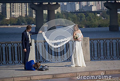 Kiev, Ukraine - September 18, 2015: Photographer working with the newlyweds Editorial Stock Photo