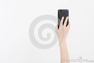 Kiev,Ukraine,06.01.2018: xiaomi mi a1.china gadgets.Hand holding black phone isolated on white clipping path inside. Top view.Mock Editorial Stock Photo