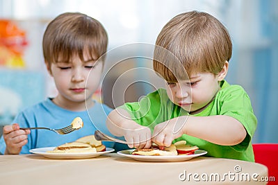 Kiids eating healthy food at home Stock Photo