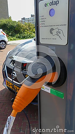 Nissan electric car charging batteries at plug in charge station in the Netherlands Editorial Stock Photo