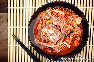 Kimchi cabbage in a bowl with chopsticks Stock Photo