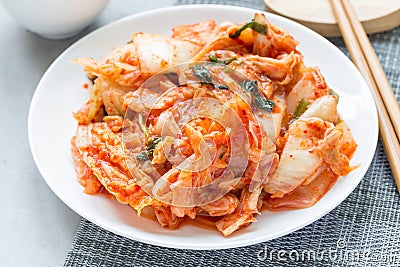 Kimchi cabbage. Korean appetizer on white plate, horizontal Stock Photo