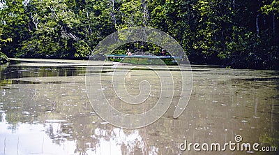 Kinabatangan, Malaysia - 09 May 2013 : Tourists on a boat cruise along the river of Kinabatangan. Editorial Stock Photo
