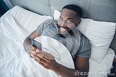 Handsome international man lying in his bed Stock Photo