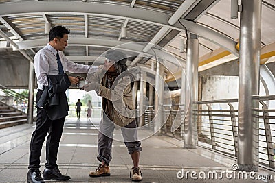 Kind Businessman give money to homeless Stock Photo