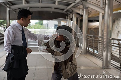 Kind Businessman give money to homeless Stock Photo