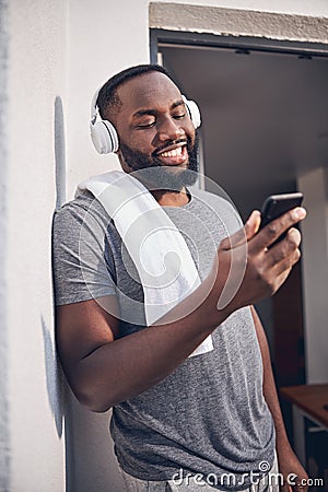 Delighted male spending sunny morning on the balcony Stock Photo