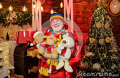 Kind grandpa with soft toys. Merry xmas. Christmas decoration. Christmas spirit. Bearded grandfather senior man Stock Photo