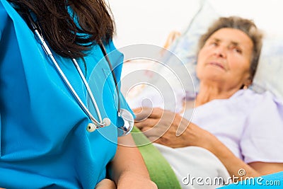 Kind Nurse with Elderly Stock Photo