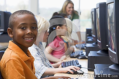 Kindergarten children learning to use computers Stock Photo