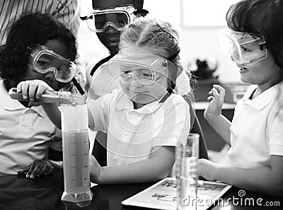 Kindergarten Students Mixing Solution in Science Experiment Laboratory Classr Stock Photo