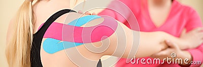 Kinesiology, physical therapy, rehabilitation banner. Female patient wearing kinesio tape on her shoulder. Stock Photo