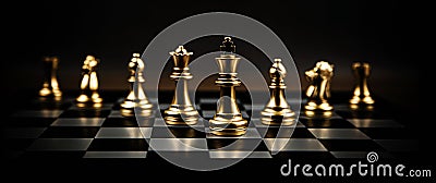 King chess piece standing on chess board with a team Stock Photo