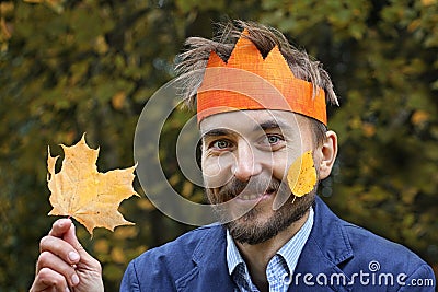 King of the fall. Funny bearded man in paper crown with yellow l Stock Photo