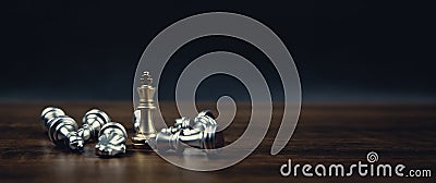 King golden chess standing in the middle of the falling silver chess. Stock Photo