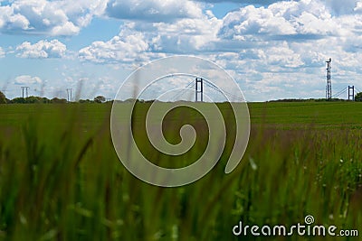 The Humber Bridge in the background with green fields in the fore ground slightly Editorial Stock Photo