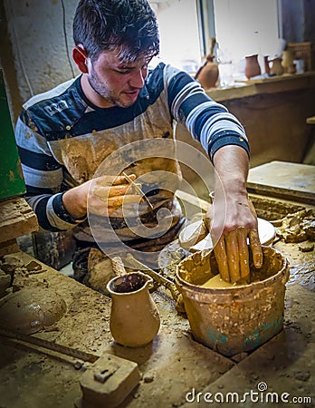Kinik, Bilecik / Turkey - September 08 2019: Man`s hands making ceramic pot on the pottery wheel. Craftsman creating pottery Editorial Stock Photo