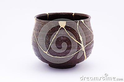 Kintsugi antique Japanese chawan restored with gold. Stock Photo