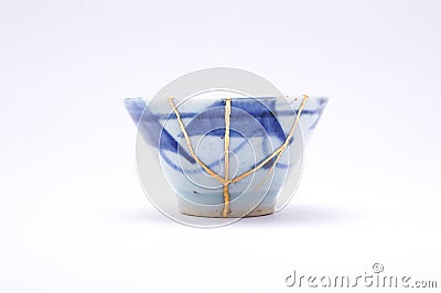 Kintsugi antique Japanese sake cup restored with gold. Stock Photo