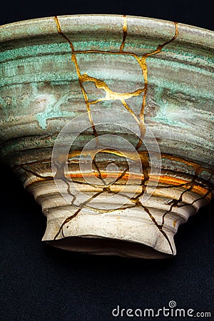 A kintsugi repaired bowl with gold. Stock Photo