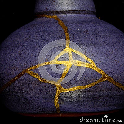 A kintsugi repaired vase with gold. Stock Photo