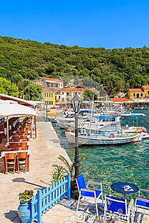 KIONI PORT, ITHACA ISLAND - SEP 19, 2014: typical Greek restaurant in Kioni port. Greece is very popular holiday destination in Editorial Stock Photo