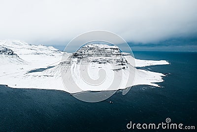 Kirkjufell, Church Mountain, Iceland's SnÃ¦fellsnes Peninsula covered by snow during winter,a mountain rising above the sea Stock Photo