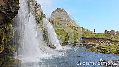 Kirkjufellsfoss waterfall near the Kirkjufell mountain, unrecognisable woman Stock Photo