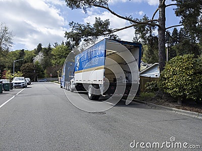 Kirkland, WA USA - circa April 2021: Angled view of a New World Van Lines moving truck in a residential neighborhood Editorial Stock Photo
