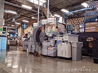 Self checkout counters being used by customers inside the new QFC grocery store off Editorial Stock Photo