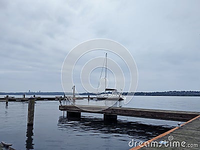 Kirkland WA USA circa July 2020: View of a single, white boat docked at the downtown Kirkland Marina on Lake Washington on an Editorial Stock Photo