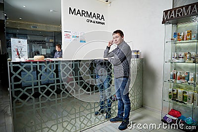 Kirov, Russia - February 25, 2019: Man waiting treatment in spa near reception and nobody near him Editorial Stock Photo