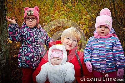 Kirov, Russia - October 23, 2022: Adult grandmother with a baby grandson and granddaughter in nature among the greenery Editorial Stock Photo