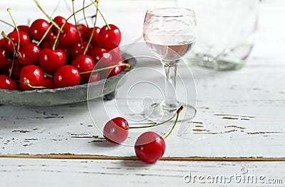 Kirsch or Kirschwasser in a glass and fresh cherry Stock Photo