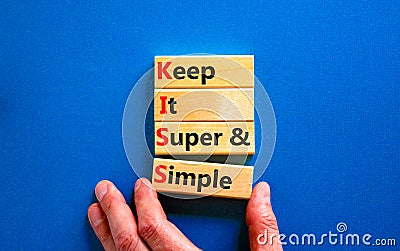 KISS keep it super and simple symbol. Concept words KISS keep it super and simple wooden blocks. Beautiful blue table, blue Stock Photo