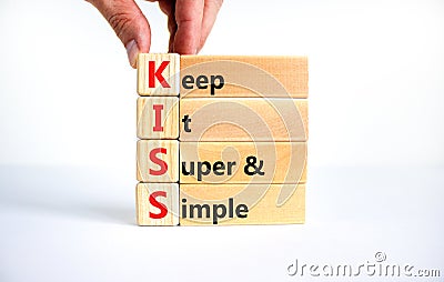 KISS keep it super and simple symbol. Concept words KISS keep it super and simple wooden blocks. Beautiful white table, white Stock Photo