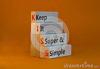 KISS keep it super and simple symbol. Concept words KISS keep it super and simple wooden blocks. Beautiful orange table, orange Stock Photo