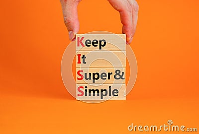 KISS keep it super and simple symbol. Concept words KISS keep it super and simple wooden blocks. Beautiful orange table, orange Stock Photo