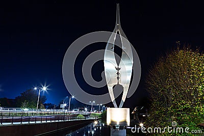 The Kiss by night, a silver metal artwork of the artist Joop van Egmond on the Nagelbrug near the Roundabout in Voorhout Stock Photo