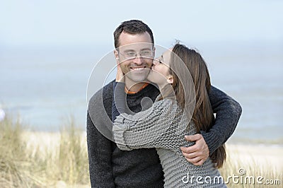 Kissing young couple at the beach Stock Photo