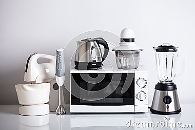 Kitchen Appliances On White Desk Stock Photo